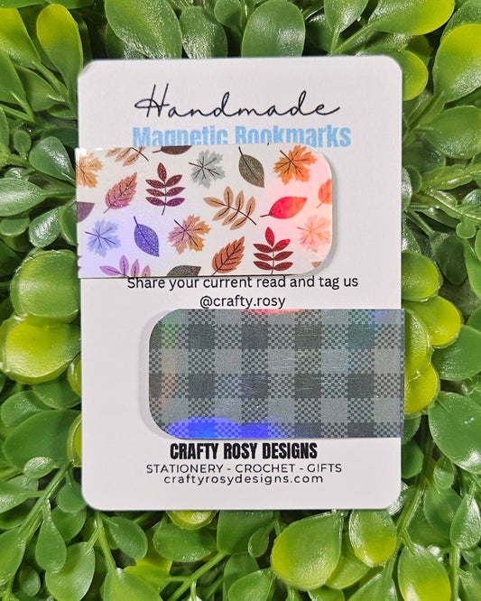 Handmade magnetic bookmarks packaging with leafy and plaid designs on a green leaf background