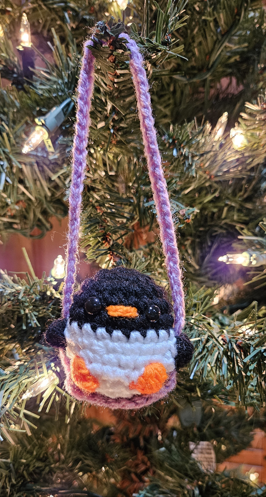 Crochet penguin on swing