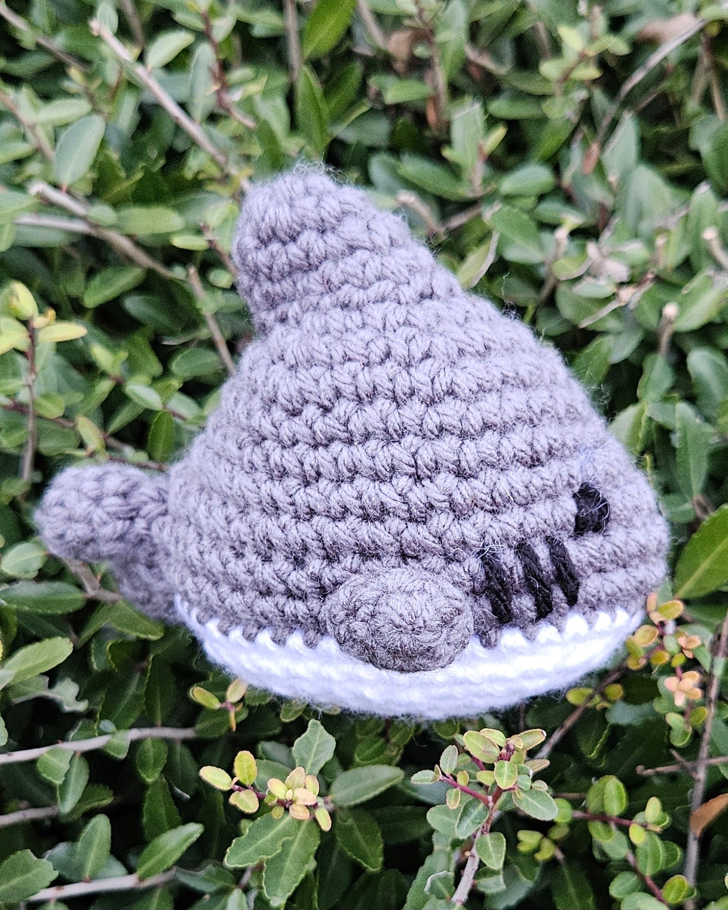 Profile side view of a crochet gray and white shark