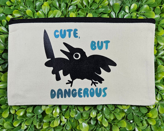 Canvas Pencil Bag with silhouette image of crow holding a knife and it says "cute, but dangerous" 